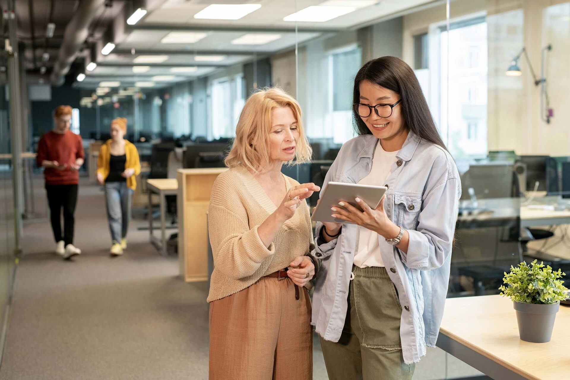 Finance professionals collaborating on tablet using Trintech integration with Microsoft Dynamics ERP for financial close