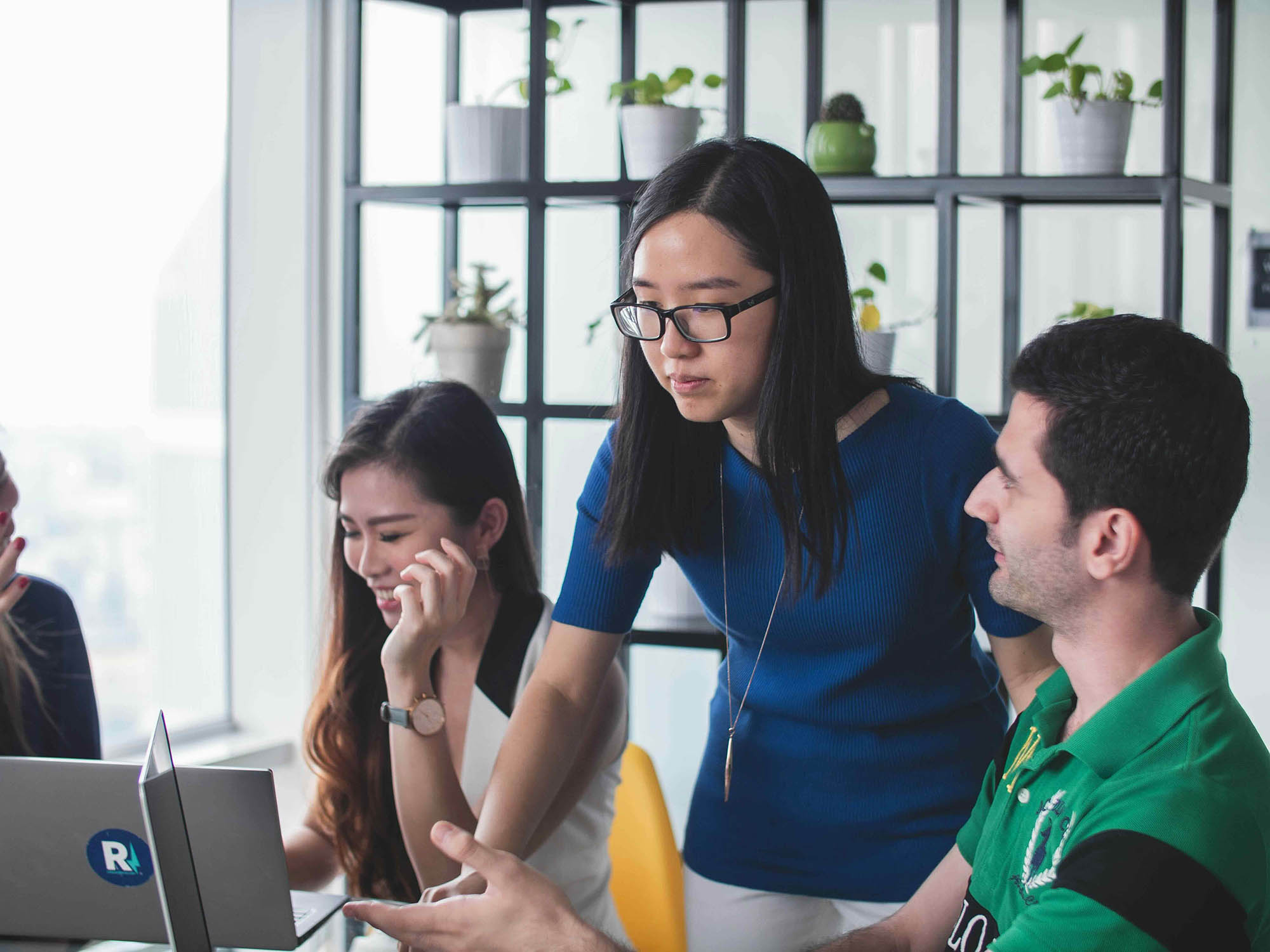 Team collaborating in office using Trintech Oracle ERP integration to streamline financial close and reporting tasks